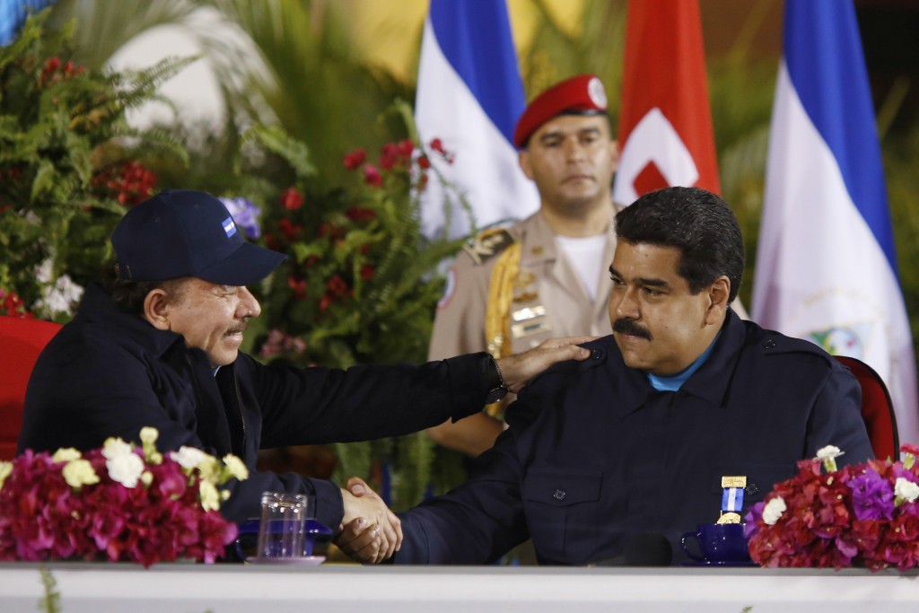 Venezuela's President Nicolas Maduro (R) and Nicaragua's President Daniel Ortega shake hands during a ceremony with Sandinista supporters in Managua in this March 13, 2015 picture provided by Miraflores Palace. Hundreds of Sandinistas marched in the avenues in support of Maduro's government and against the new sanctions imposed by the U.S. on a group of officials in Venezuela. Picture taken March 13, 2015. REUTERS/Miraflores Palace/Handout via Reuters (NICARAGUA - Tags: POLITICS) ATTENTION EDITORS - THIS PICTURE WAS PROVIDED BY A THIRD PARTY. REUTERS IS UNABLE TO INDEPENDENTLY VERIFY THE AUTHENTICITY, CONTENT, LOCATION OR DATE OF THIS IMAGE. THIS PICTURE IS DISTRIBUTED EXACTLY AS RECEIVED BY REUTERS, AS A SERVICE TO CLIENTS. FOR EDITORIAL USE ONLY. NOT FOR SALE FOR MARKETING OR ADVERTISING CAMPAIGNS