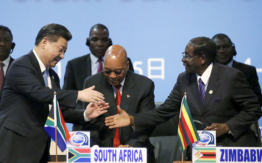 China's President Xi Jinping (L) shakes hands with Zimbabwe's President (R) Robert Mugabe while South Africa's President Jacob Zuma looks on during a Forum on China-Africa Cooperation in Sandton, Johannesburg, December 4, 2015. REUTERS/Siphiwe Sibeko - RTX1X5GJ