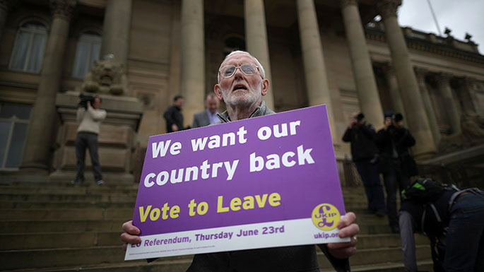A Vote to Leave campaigner holds a placard as Leader of the United Kingdom Independence Party (UKIP), Nigel Farage campaigns for votes to leave the European Union in the referendum on May 25, 2016 in Bolton, England. Nigel Farage took his battle bus to Bolton encouraging British people to vote to leave the EU on 23rd June 2016. (Christopher Furlong/Getty Images)