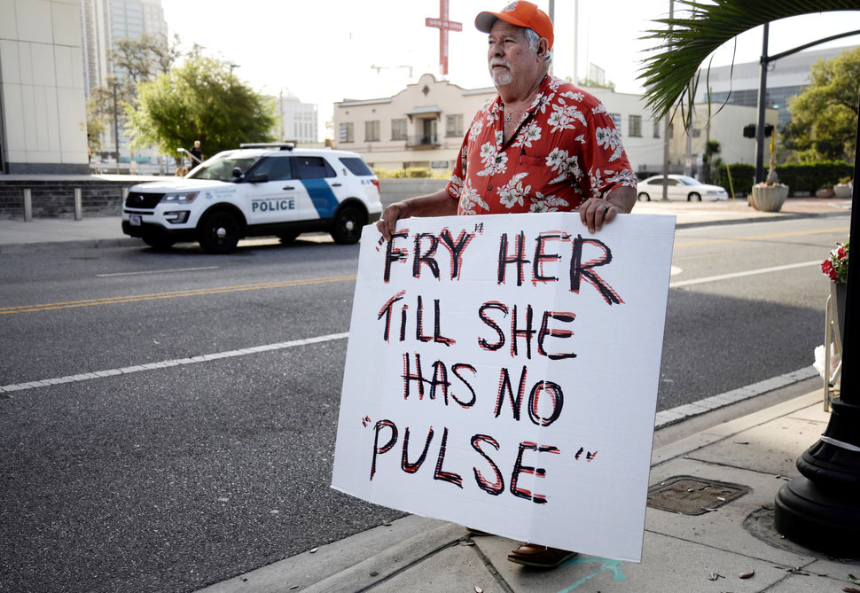 Bob Kunst protests against the widow of the Pulse nightclub shooter Noor Salman, who faces charges of aiding her husband in killing 49 people in 2016, outside the federal court house in Orlando, Florida, U.S. March 1, 2018. REUTERS/Joey Roulette